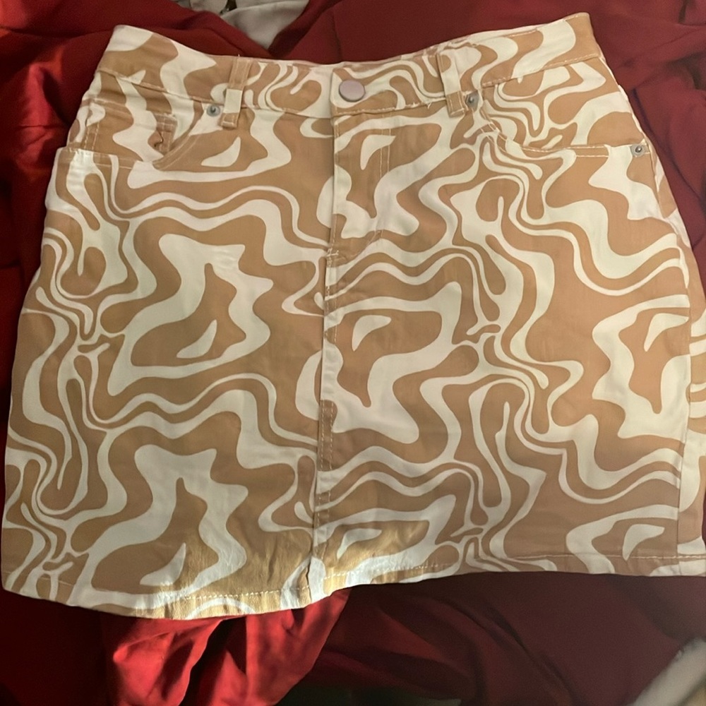 Tan skirt with pretty design. Not long but not that short.